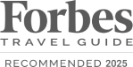 The image shows a logo for Forbes Travel Guide with the text "Recommended 2023" beneath it. logo on footer section.