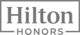 The image shows the "Hilton Honors" logo in a rectangular frame, featuring bold text.