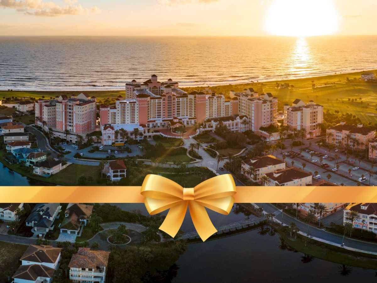 A scenic coastal view at sunset with buildings near the shoreline and a golden ribbon overlay at the bottom of the image.