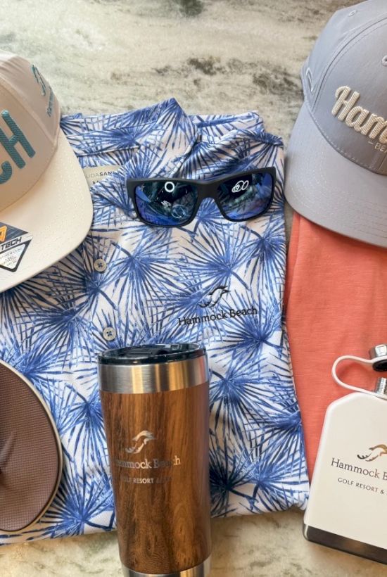 A beach-themed ensemble: two caps, sunglasses, a blue palm shirt, an orange shirt, sandals, a tumbler, and a flask.