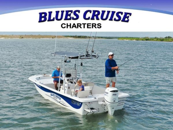 A small group of people on a Blue&rsquo;s Cruise charter boat fishing on calm blue waters, with a logo banner above saying &ldquo;BLUES CRUISE CHARTERS.&rdquo;