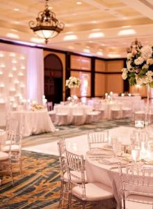 A cozy restaurant dining room with elegant table settings, warm lighting, and marble surfaces; a refined, intimate atmosphere.