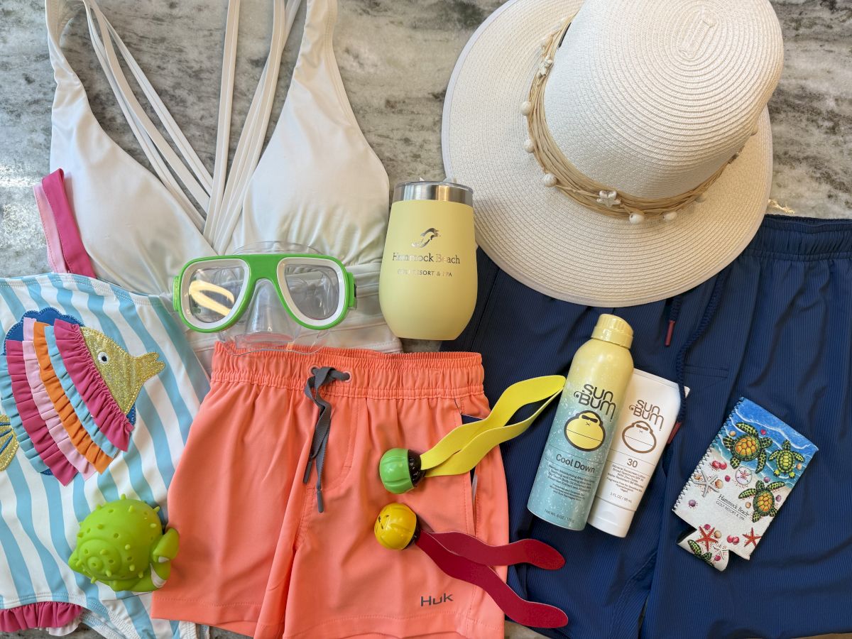 Beach essentials: swimsuit, hat, goggles, tumbler, sunblock, swim shorts, ball toys, and socks. Ready for a fun day in the sun!
