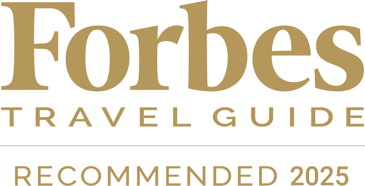 The image shows "Forbes Travel Guide Recommended 2025" in gold text.