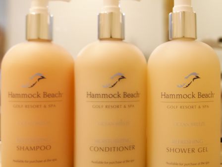 Three bottles with pumps labeled as shampoo, conditioner, and shower gel from Hammock Beach Resort & Spa are displayed.